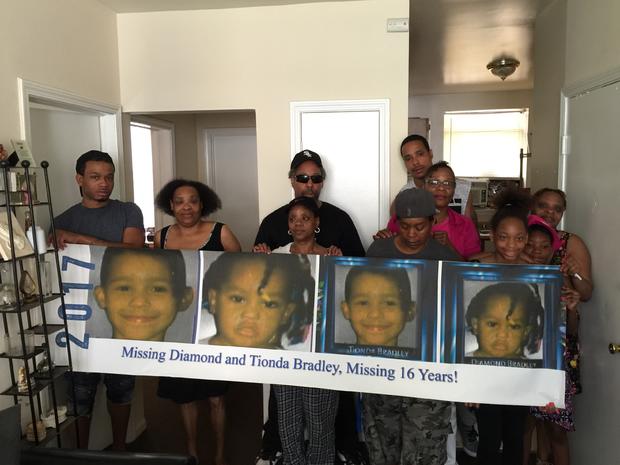 Tionda and Diamond Bradley family with a banner